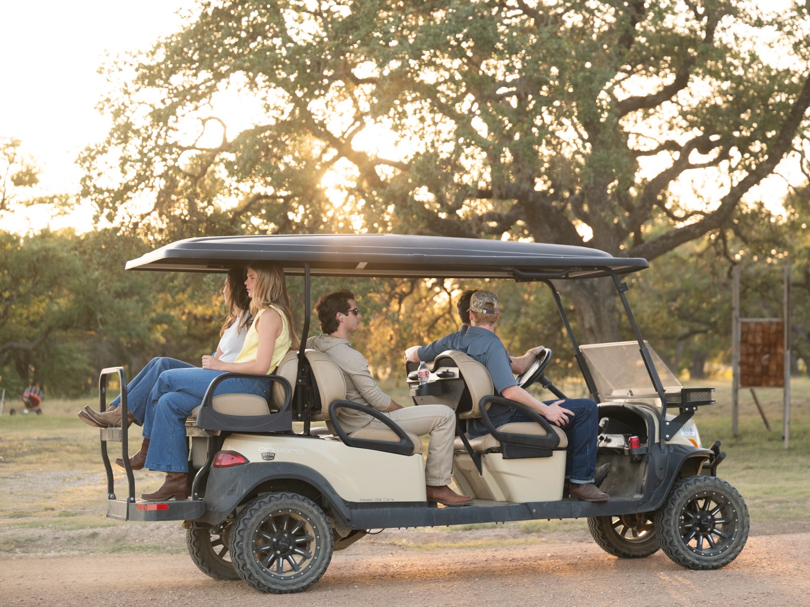 Guests riding out to the course at golden hour
