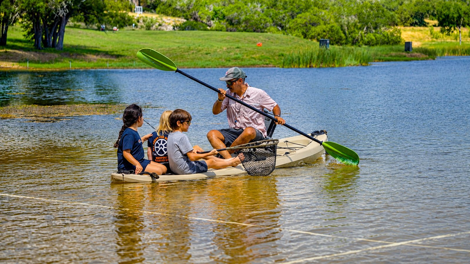 A Waypoint guide teaching students from a kayak on the lake